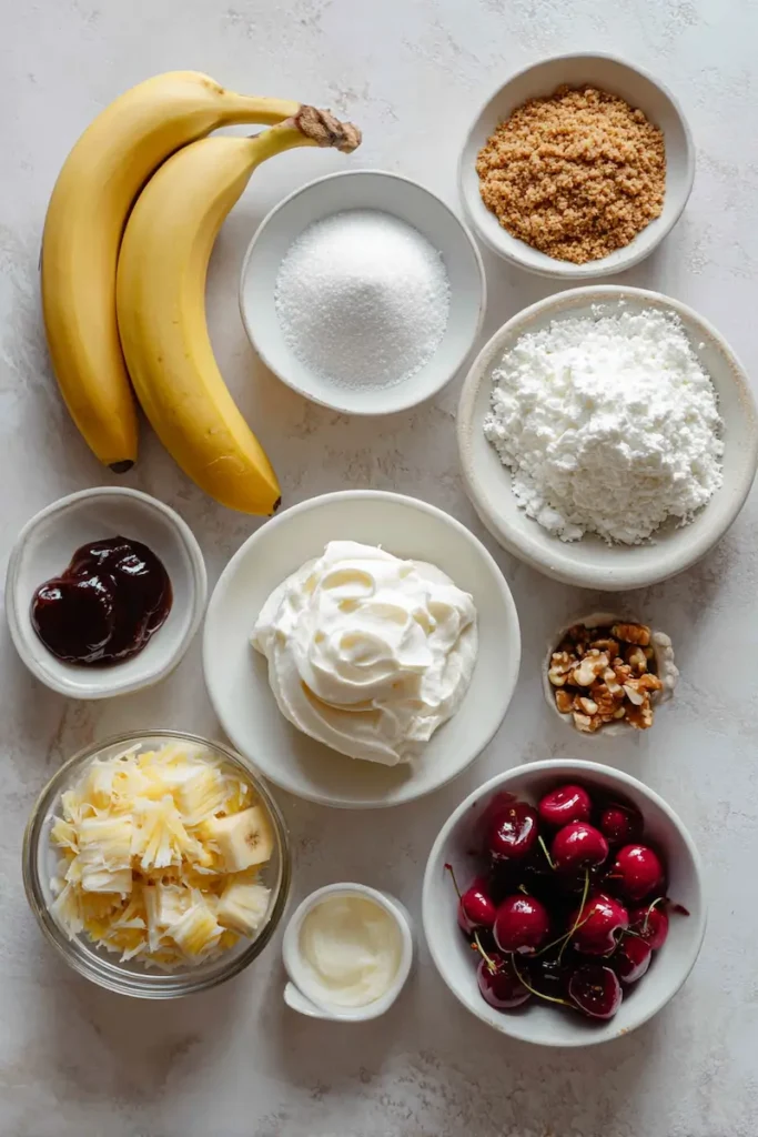 No-Bake Banana Split Cake 3 Ingredients for no-bake banana split cake including graham crackers, bananas, pineapple, whipped topping, chocolate syrup, nuts, and cherries.