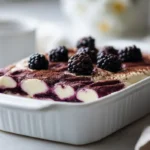 Vegan blackberry tiramisu served in neat creamy layers with fresh blackberries, soft cookies, and a smooth dairy-free cream topping.